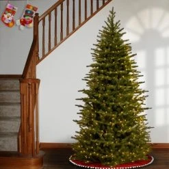 National Tree Company Pre-Lit 'Feel Real' Artificial Slim Christmas Tree, Green, Nordic Spruce, White Lights, Includes Stand, 6.5 feet